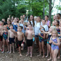 <p>River Edge Swim Team celebrates with the first place trophy.</p>