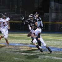 <p>The Hasbrouck Heights quarterback looks for the end zone during the Super Bowl game against Carlstadt-East Rutherford.</p>