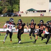<p>Senior Falcon Sam White Jr. sweeps right around Hasbrouck Heights&#x27; defensive line.</p>