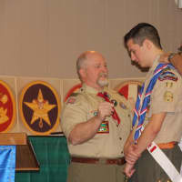 <p>Troop 17 assistant scoutmasters present Victori with the Eagle Badge and Neckerchief.</p>