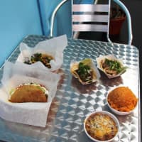 <p>A sampling of menu items, including shrimp and beef tacos, TJ tacos, refried beans and Mexican rice.</p>