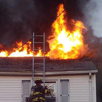 <p>The wind-blown three-alarm fire began in the basement or first floor of the 2½-story house on Halstead Place house before flames eventually shot through the roof. </p>