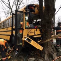 <p>Westport firefighters work to free a school bus driver trapped following a crash.</p>