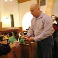 <p>The flame makes the rounds during the Peace Light Ceremony at Corpus Christ Church in Hasbrouck Heights Friday night.</p>