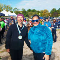 <p>Emily Walgenbach of Stamford, CancerCare’s Walk/Run for Hope Women’s 5 K winner (left), with Corey Cenatiempo, Regional Special Events Manager for CancerCare, right, at Jennings Beach in Fairfield on Oct. 4.</p>