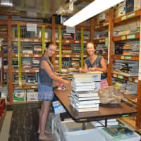 <p>Erin Singleton and her 12-year-old daughter Riley, sort books for the 57th Annual Mark Twain Library Book Fair, held over Labor Day weekend at the Redding Community Center on Lonetown Road.</p>