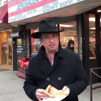 <p>Essen &amp; Fressin&#x27;s Jonathan Petak reviewing a pizza slice in Brooklyn equipped with his fake teeth.</p>