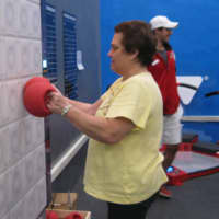 <p>Member Evelyn Stier exercising with the ExcerZone&#x27;s T-Wall. </p>
