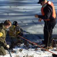 <p>Fairfield Firefighters Rob Petrie (in the yellow rescue suit) and Nick Gentile (with the hat and life jacket) along with Animal Control Officer Joe Felner (in the green uniform) rescue Delilah after she became trapped on an ice-covered pond</p>
