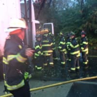 <p>Firefighters work to free a driver from a damaged truck early Wednesday morning. </p>