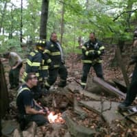 <p>Fairfield firefighters look on as owner Brian Kielitz is reunited with his dog. </p>
