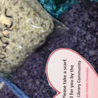 <p>Members of the Purls of Wisdom Knitting Group and the Sewing Salon gave away hundreds of free scarves, hats and mittens in the second annual Yarn Bombing at Fairfield Public Library.</p>