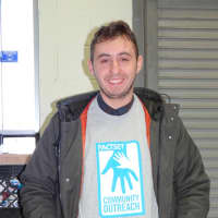 <p>One of the volunteers from Norwalk-based FactSet who helped pack food into bags and distribute turkeys to P2P clients.</p>