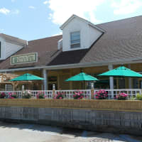 <p>The rustic enclosed patio at Farm to Table Bistro in Fishkill is surrounded by pretty flowers.</p>