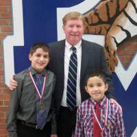 <p>Dean Fejes, left, an eighth-grader at Fox Meadow High/Middle School, and Jonell Rios Losado, who attends the Walden School, flank schools Superintendent Dr. James M. Ryan after ceremonies in November honoring the boys&#x27; achievements.</p>