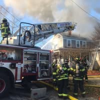 <p>Crews working to contain a fire at 11A Union Street in Natick</p>