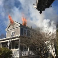 <p>Smoke and flames coming from a home on Union Street in Natick</p>