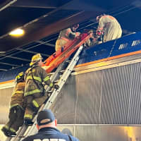 <p>DC Fire and EMS working to remove the victim from atop a rail car during an earlier incident at Union Station. This was taken after the high-voltage catenary was de-energized, grounded, and tested in order to make the scene safe</p>