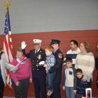 <p>New Milford Fire Chief Alan Silverman sworn in by Council President and Fire Liaison Dominic Colucci, surrounded by family members.</p>