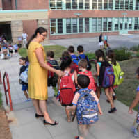 <p>Dows Lane Elementary School Principal Deborah Mariniello greets her students on the first day of school. </p>