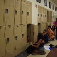 <p>Students check out lockers on first day.</p>