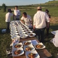 <p>Chefs prepare the plates at a recent dinner at Fishkill Farms, a family-owned orchard in Hopewell Junction.</p>