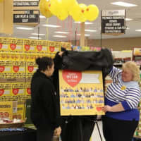 <p>ShopRite of Fishkill associates Kelsey Wright, left, and Dawn Doughty-Myers unveil a poster depicting a cereal box that features their photos. ShopRite&#x27;s Partners In Caring Cheerios contest raised $1.4 million to fight hunger.</p>