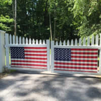 <p>American flags decorate a gate in Bedford</p>