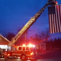 <p>Somers firefighters hung a huge American flag from a ladder truck to help welcome member Jack Foley  home from the Marines.</p>