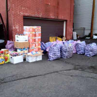 <p>Bags and boxes of food are ready to load onto the van for an outreach.</p>