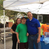 <p>Paul Jetter, right, and a parent pose with a youngster wearing his Safely Back Home apparel at the Bergen County Zoo in Paramus.</p>