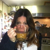 <p>Donna Massaro, owner/chef at The Freight House Café, enjoys a cup of java made with beans from Bear Mountain Coffee Roasters.</p>