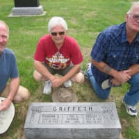 <p>Bill Griffeth with his first cousin, Doug, and brother, Chuck, at the headstone of their great-grandparents, Orson and Martha Griffeth, in a cemetery outside Munden, Kansas in August 2012. All three had DNA tests done.</p>