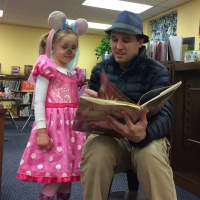 <p>Daniel Kurcz reads a story to Zoe, 3.</p>