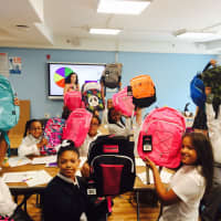 <p>Students at Atmosphere Academy with their new backpacks.</p>