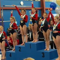 <p>Darien Level 3 gymnasts topping the podium in the age eight All Around were from left, Lindy Mueller, Penelope Arredondo, Anna Altier, Ava Licata, Sydney Berk, Annelise Enters and Sophia Gaffer.</p>