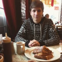 <p>An Allendale Eats customer holds it together before getting down with his french toast.</p>