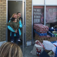<p>Kristen Hajiantoniou, 2-year-old Yianni and 11-year-old Maria get a holiday surprise from dozens of firefighters, police officers , Santa Claus and Bergen County moms — all bearing gifts.</p>