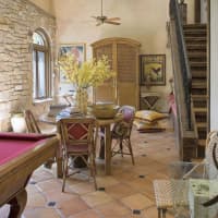 <p>The game room features a pool table and French doors leading to the outdoor terrace.</p>