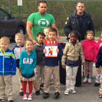 <p>Sgt. John Lesica showed the school children his police vehicle and handed out coloring books</p>