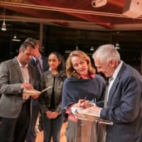 <p>Retired U.S. Gen. Wesley Clark signs copies of his latest book after a talk in New Canaan.</p>