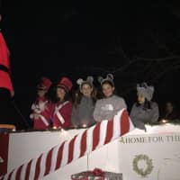 <p>Gia Macaluso of Westwood and friends smile from a float in the Westwood Parade of Toys.</p>