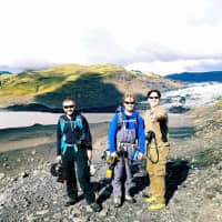 <p>Robert Gilligan (right) poses with two adventurers while hiking a glacier in Iceland.</p>