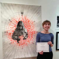 <p>Gina Lindner with her award-winning &quot;Apprehension of Loss&quot; at the OSilas Gallery.</p>