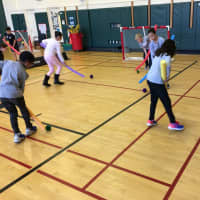<p>Glenville School physical education students play floor hockey.</p>