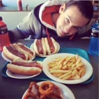 <p>A customer at Goffle Grill in Hawthorne takes a selfie with a tray full of Texas weiners &quot;all the way&quot; with sides of fries and onion rings.</p>