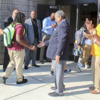 <p>State Sens. Marilyn Moore, left, and  Ed Gomes, center, greet students coming into Bassick High School Thursday.</p>