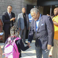 <p>State Sen. Ed Gomes welcomes a youngster back to classes at Dunbar School in Bridgeport.</p>
