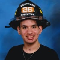 <p>Aris Gomez was just a few months shy of becoming a probationary firefighter in Thiells when he nearly died from a brain aneurysm . Now disabled, he is an honorary firefighter at the David B. Roche firehouse in the Thiells Roseville Fire District.</p>
