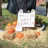 <p>A scarecrow created by the Ossining Girl Scouts welcomes the Great Pumpkin.</p>